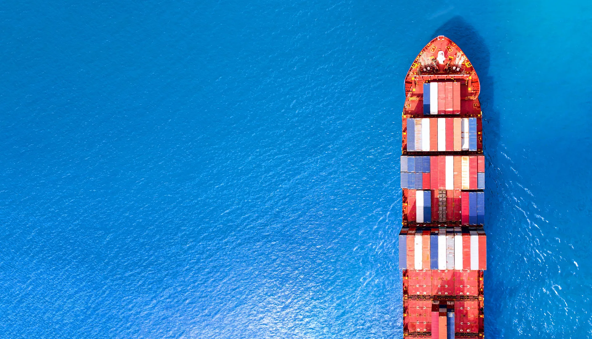 Large cargo vessel at sea in atmospheric conditions